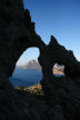 Kalymnos - the 'eye' in this sharp arête (often with 'added climber') is much used to promote rock climbing on Kalymnos; this view taken just after dawn with Telendos Island in the background