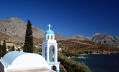 Kalymnos - whitewashed bell-tower of the small chapel at Emborios looking across the bay