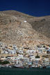 Kalymnos - the steep mountainside to the north of Pothia harbour with pastel-washed houses terraced up it and a small chapel perched on a shoulder near the top