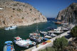 Kalymnos - fishing boats lined up along the harbourside at Vathy with 'trip boats' in the distance