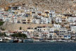 Kalymnos -  looking North across the harbour at Pothia, ranks of colourful houses rise steeply up the mountainside