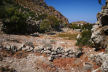 Nisyros - looking along the small, high-level valley towards Nyfios with clear indications of its farming past in the foregound and the large rock on the left middle-ground which has clear marks of roofing joists thought to date to prehistoric settlement