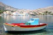 Symi - fishing boat moored at Pedi with the village behind