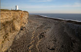 rocky foreshore, southern cliff and 'short' lighthouse at Nash Point
